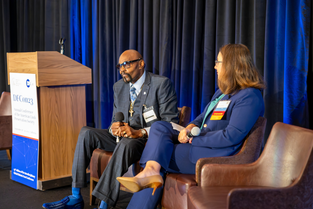 George Woods speaking on stage at DFCon 2023